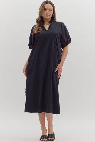 Woman wearing a black dress against a white background