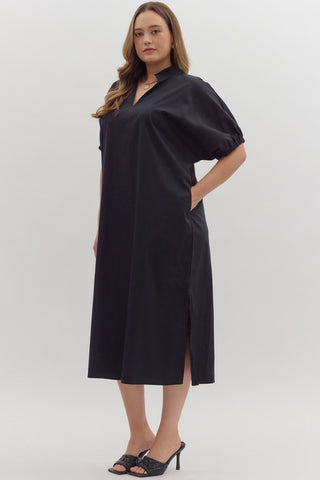 Woman wearing a black dress with a white background