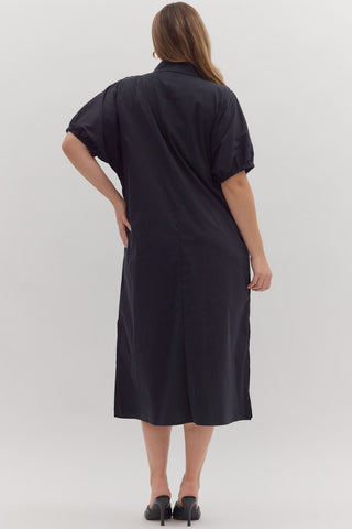 Woman wearing a black dress against a white background