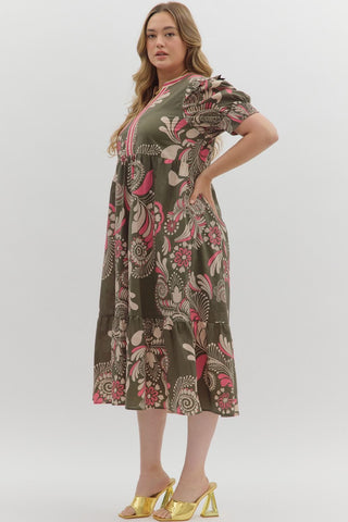 Woman wearing a floral dress with gold shoes on a white background