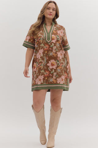 Woman wearing a floral dress with a plain background
