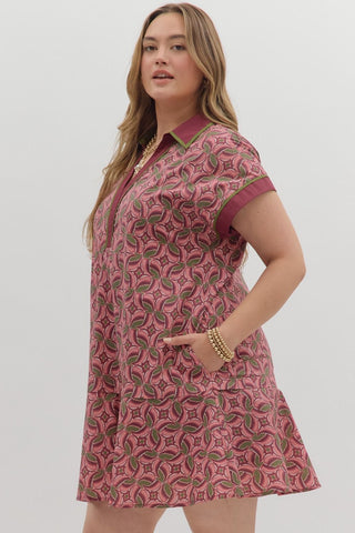 Woman wearing a pink patterned dress on a white background