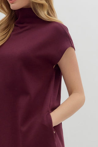 Maroon dress worn by a person on a white background