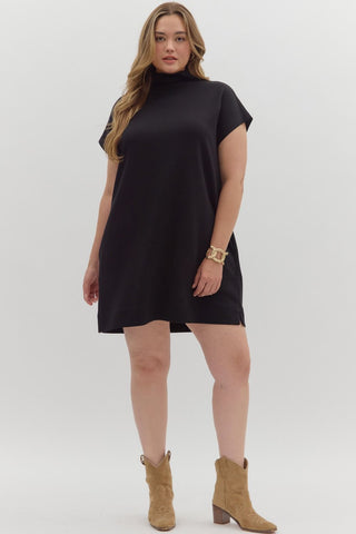 Woman wearing a black dress with short sleeves on a white background
