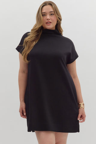 Woman wearing a black dress against a white background