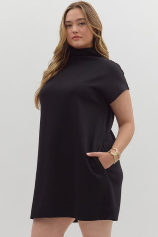 Woman wearing a black dress against a white background