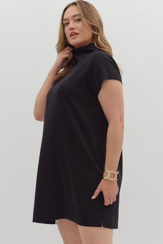 Woman wearing a black dress against a white background