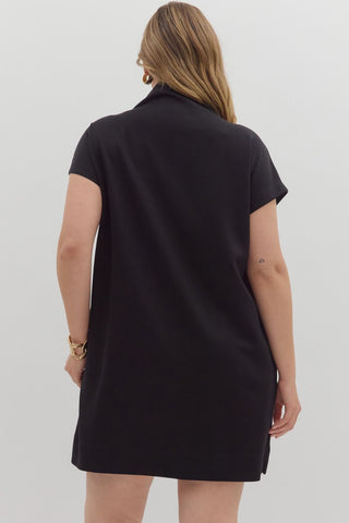 Person wearing a black dress against a white background