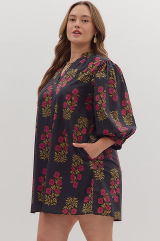 Woman wearing a dark floral dress on a white background