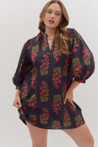 Woman wearing a dark floral dress on a white background