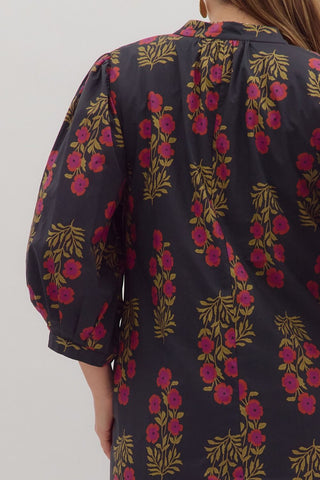 Floral patterned shirt worn by a person on a plain background