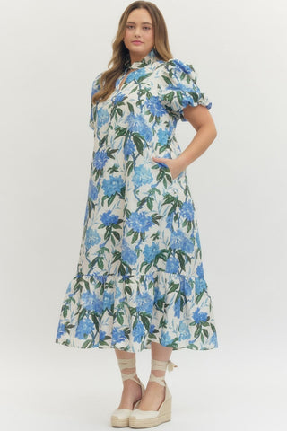 Woman wearing a floral dress with blue flowers on a white background