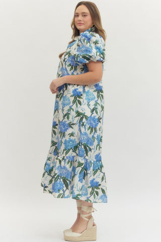 Woman wearing a floral dress with blue flowers on a white background