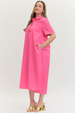 Woman wearing a bright pink dress on a white background