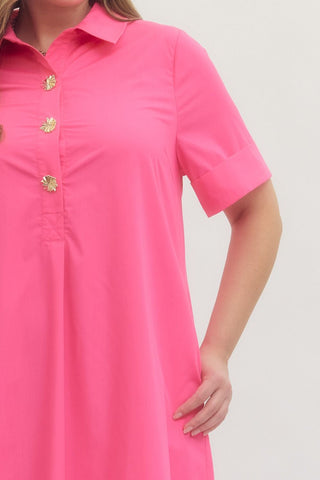 Pink dress with gold buttons on a plain background