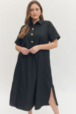 Woman wearing a black dress with gold buttons on a white background