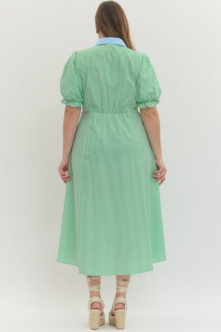 Woman wearing a green striped dress against a white background