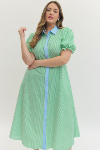 Woman wearing a green checkered dress with a blue stripe on a white background