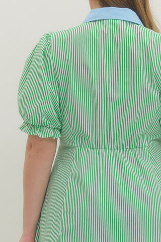 Green and white striped dress with puffed sleeves on a plain background