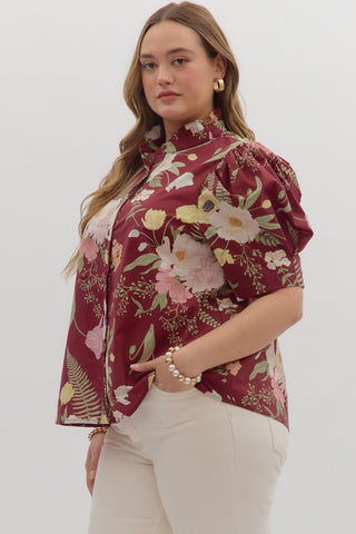 Woman wearing a floral blouse with a white background