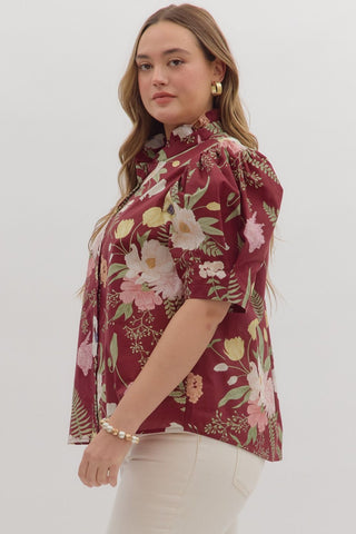 Woman wearing a floral blouse with a white background