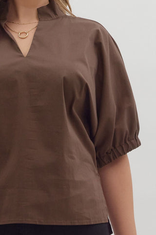 Brown blouse with short sleeves on a plain background