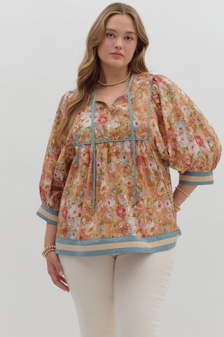 Woman wearing a floral blouse with puff sleeves on a white background