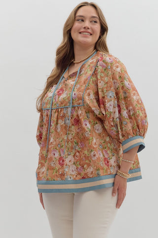 Woman wearing a floral blouse with a plain background
