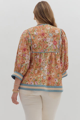 Woman wearing a floral blouse with a plain background
