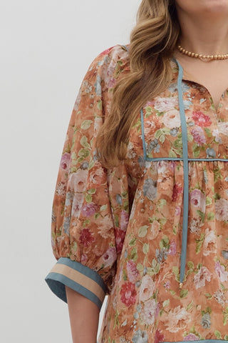 Floral dress with blue trim on a plain background
