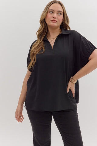 Woman wearing a black outfit against a white background