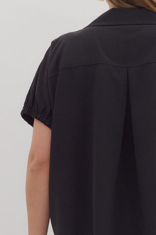 Black shirt worn by a person on a white background