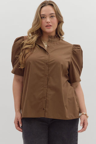 Woman wearing a brown blouse with puff sleeves on a white background