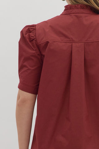 Red shirt worn by a person on a white background