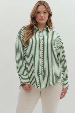 Woman wearing a green and white striped shirt against a white background