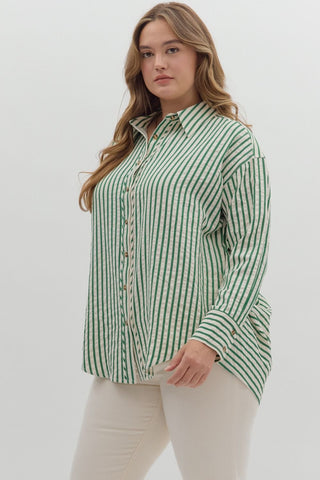 Woman wearing a green and white striped shirt against a white background