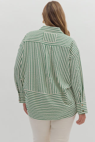 Person wearing a green and white striped shirt on a plain background