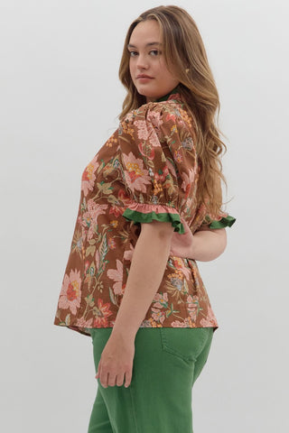 Woman wearing a floral blouse with a plain background