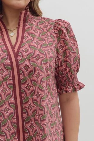 Close-up of a pink patterned dress with a plain background