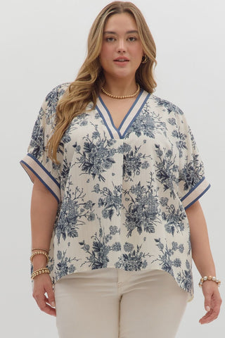 Woman wearing a floral blouse with a plain background