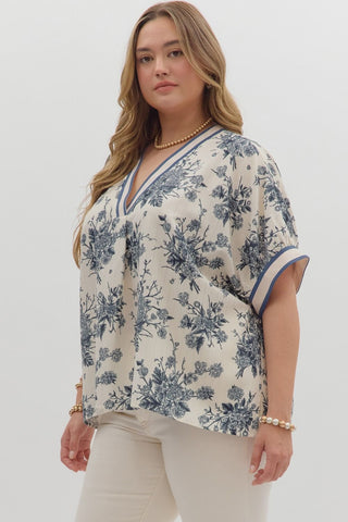 Woman wearing a floral blouse with a plain background