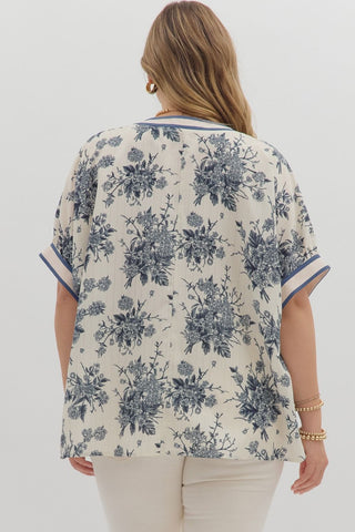 Woman wearing a floral patterned blouse on a white background