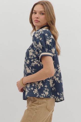 Woman wearing a blue floral blouse against a white background