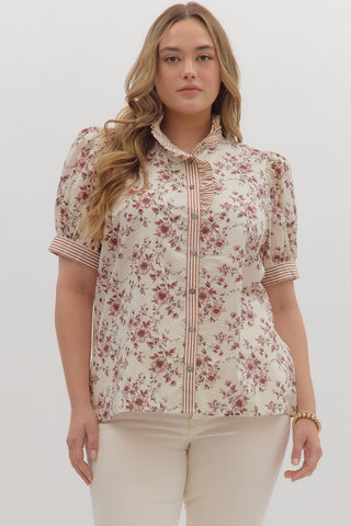 Woman wearing a floral blouse with a white background