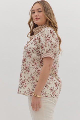 Woman wearing a floral blouse against a white background