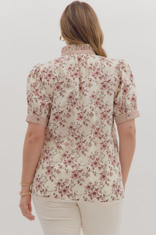 Woman wearing a floral blouse with a white background