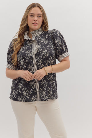 Woman wearing a floral blouse with a white background