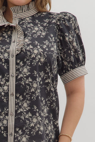 Floral dress with striped collar and cuffs on a plain background