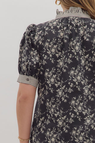 Floral patterned dress with puff sleeves on a plain background
