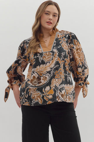 Woman wearing a floral blouse with long sleeves on a white background